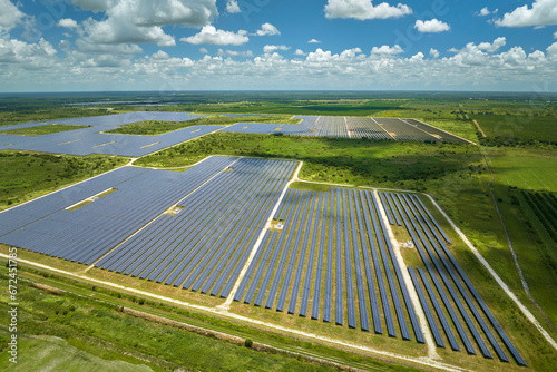 Aerial view of big sustainable electric power plant with many rows of solar photovoltaic panels for producing clean electrical energy. Renewable electricity with zero emission concept
