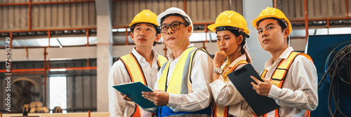 Slika na platnu Group of engineer with factory foreman or supervisor oversee training program or conduct safety inspection on metalwork manufacturing machine in heavy industrial factory