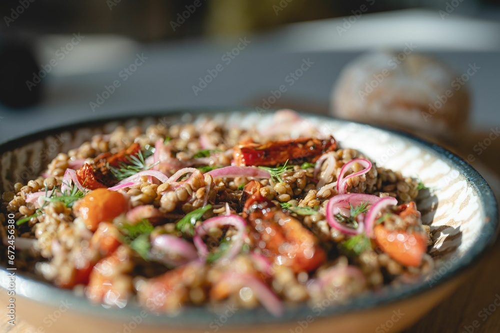 possesseds in a bowl on a plate with onions and carrots possesseds in a bowl on a plate with onions and carrots