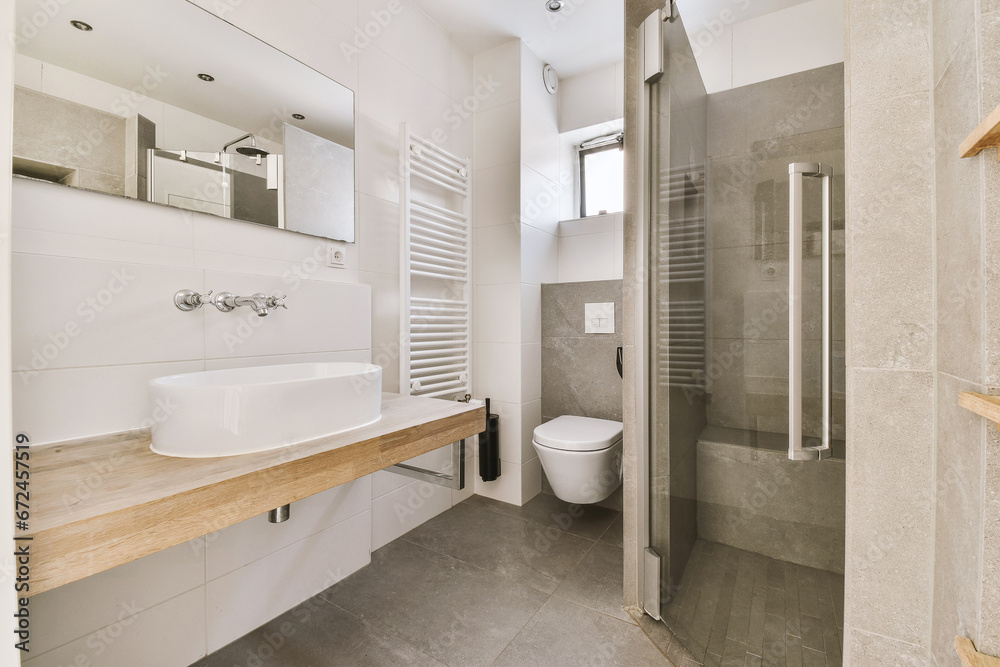 Modern white bathroom with toilet seat and shower cabin
