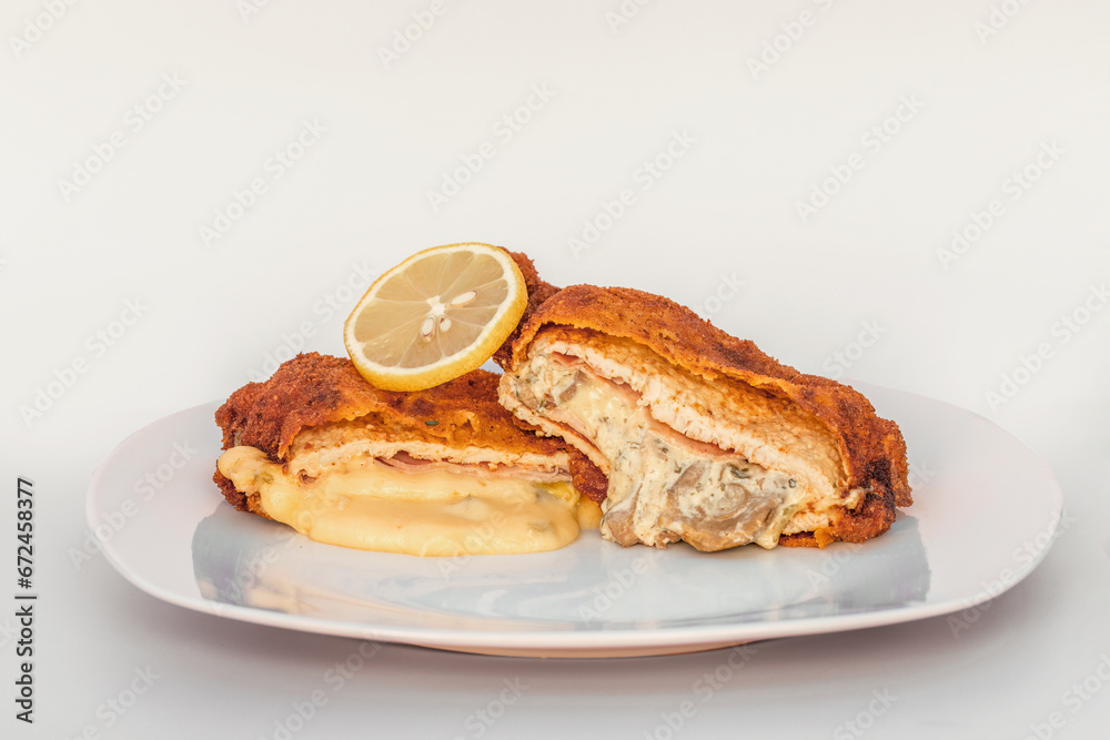 Variation of a Cordon Bleu with alternate filling on a plate on white background Variation of a Cordon Bleu with alternate filling on a plate on white background