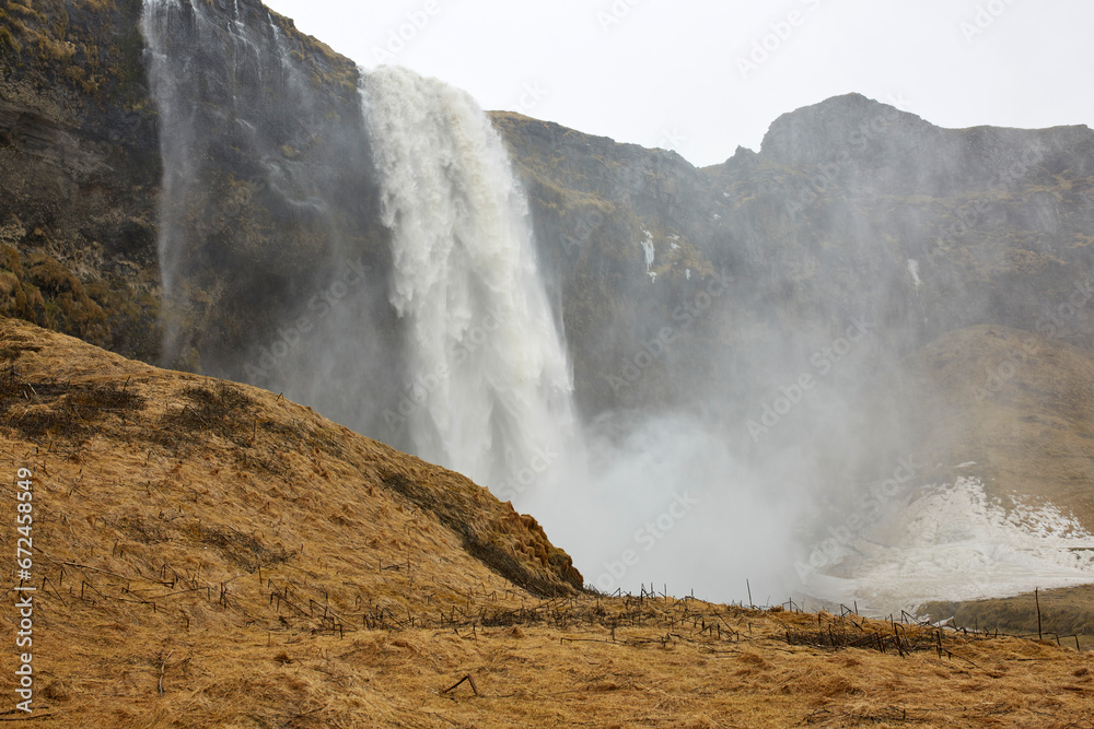 Beautiful waterfall and rocky cliff at Iceland Beautiful waterfall and rocky cliff at Iceland