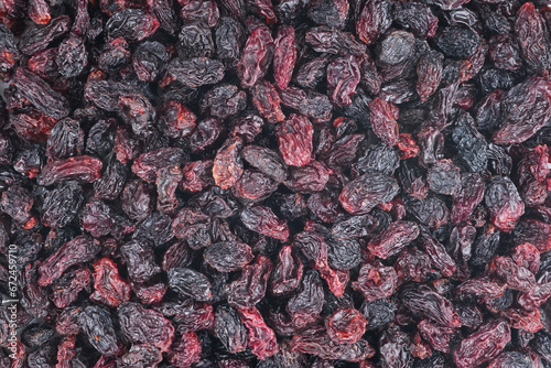 Background of big raw dried raisins, situated arbitrarily