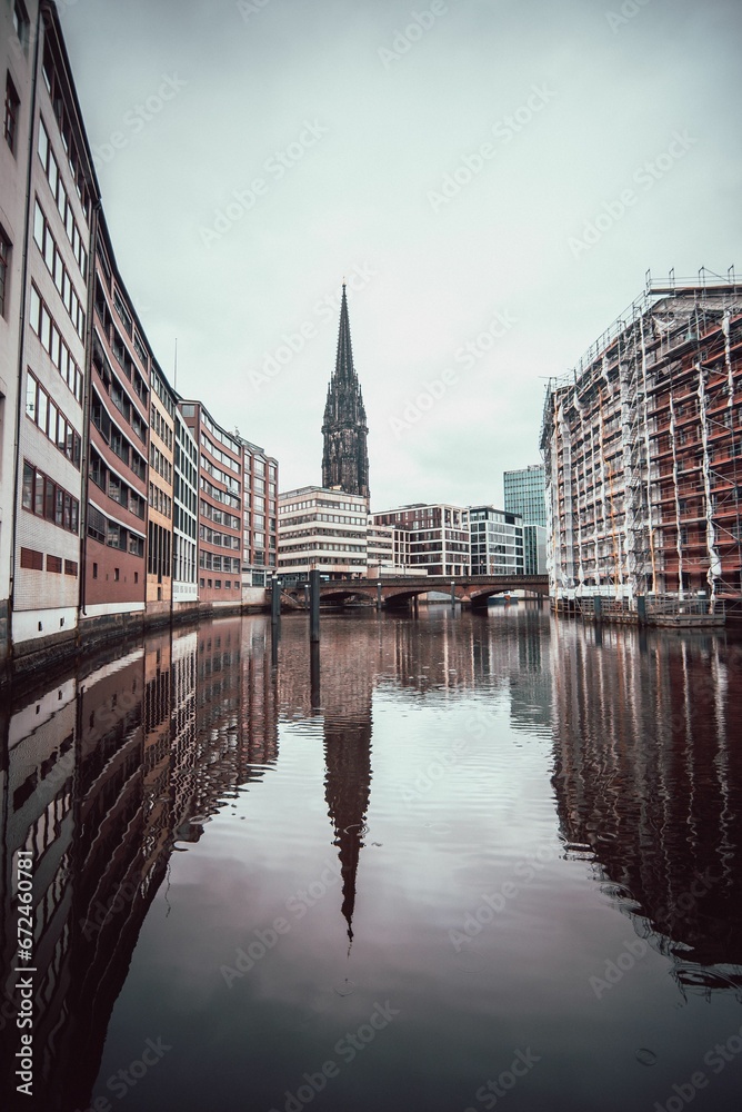 Vertical of a canal flowing through Hamburg, Germany on a cloudy day