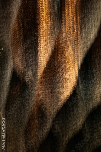 Closeup of a brown fabric of a cloth in a warm, natural light