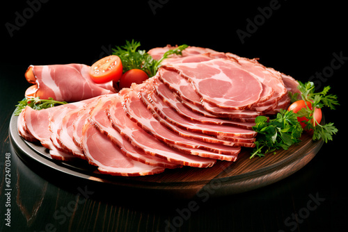 Wooden board beautifully presented with a variety of delicious ham slices