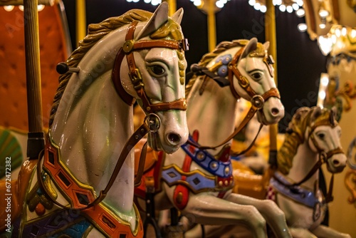 Horse figurines on a children's carousel in an amusement park