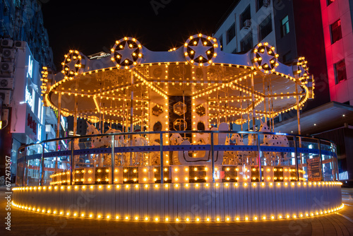 Brightly illuminated modern carousel in Qingdao China at night