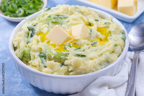 Traditional Irish dish Colcannon or mashed potato with green cabbage and butter, horizontal