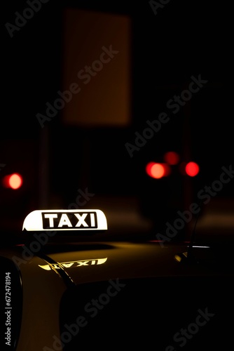 Yellow taxi car parked on a city street at night