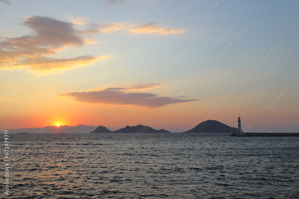 Naklejka premium sunset on the beach. Seaside town of Turgutreis and spectacular sunsets. Selective Focus.