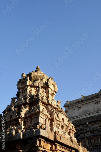Temple tower with Moon in the blue sky background.