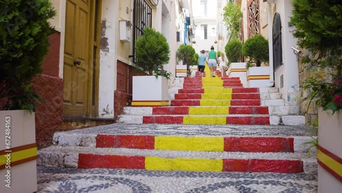 Family Walking Up Stairs Painted In Spain Colours In Calp Old Town photo