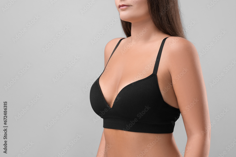 Fototapeta premium Woman with beautiful breast on light grey background, closeup. Space for text