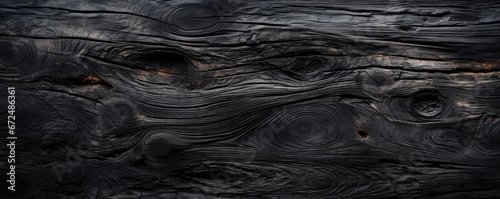 Burnt wood texture background, wide banner of charred black timber. Abstract pattern of dark scorched tree. Concept of charcoal, smoke, coal, grill, embers, fire, barbecue, grunge photo
