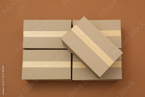 Many cardboard boxes on brown background, flat lay