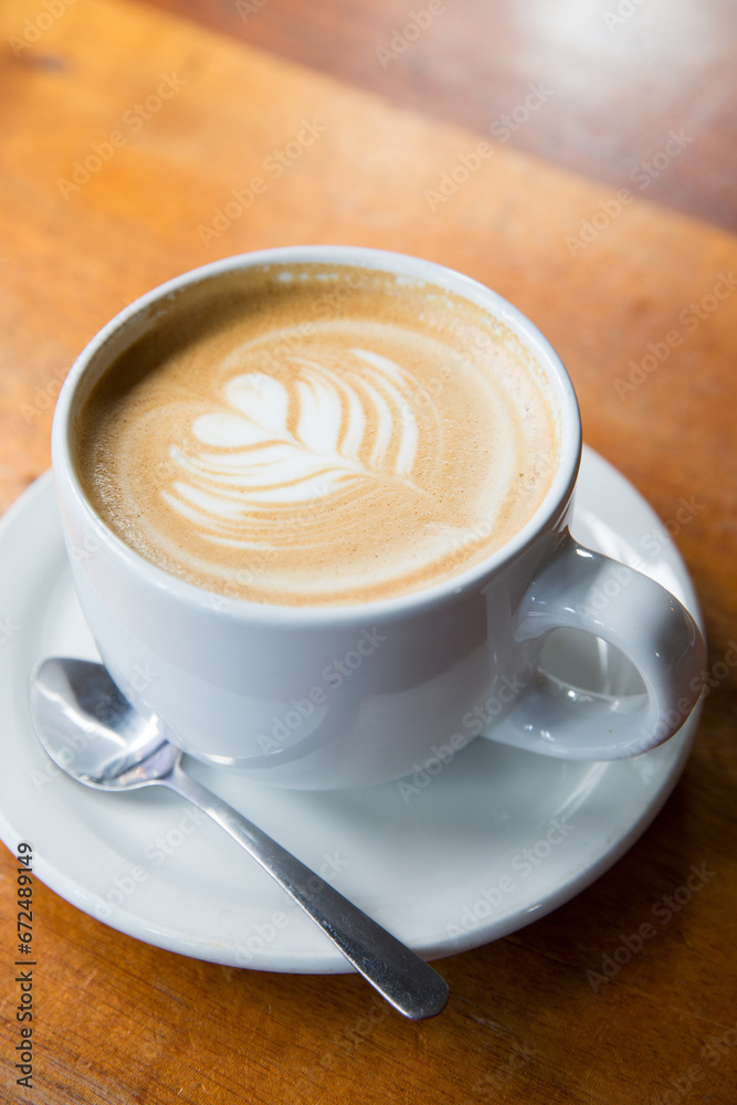 White Cup of Cappuccino over a wood table. White Cup of Cappuccino over a wood table.