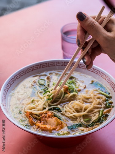 Person eating a bowl of Ramen in Osaka, Japan.