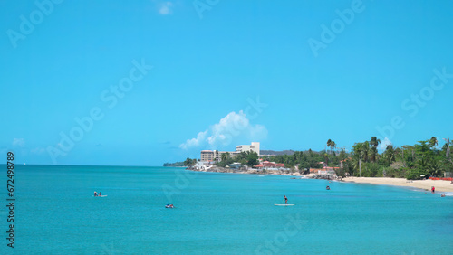 People enjoying water sports at Playa Los Almendros Rincon Puerto Rico photo