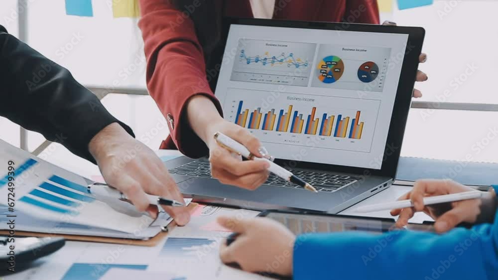 Two creative business people meeting and planning use post it notes sticky note on desk to share idea, Analysis data chart and graph with teamwork strategy brainstorming in office.