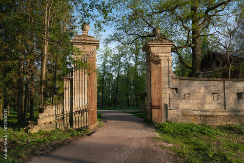 View of the Menagerie (Zverinskiye) Gate - stone gate to the Eagle Grove, between the Menagerie and the Palace Park in Gatchina Park on a sunny summer day, Gatchina, Leningrad region, Russia