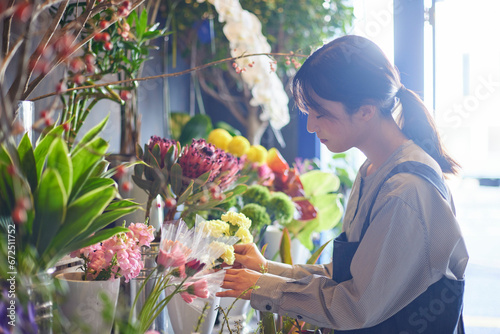 花屋で働くエプロンをきた日本人の女性 photo