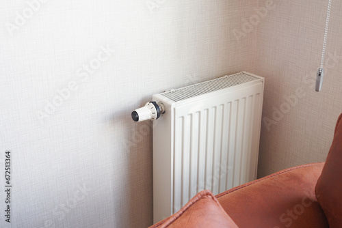 White radiator on grey white wall. apartment heating installation system,  photo