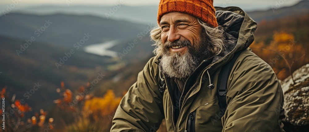 Mature, content, and happily smiling hiker enjoying hot tea while venturing outside. Mature, content, and happily smiling hiker enjoying hot tea while venturing outside.