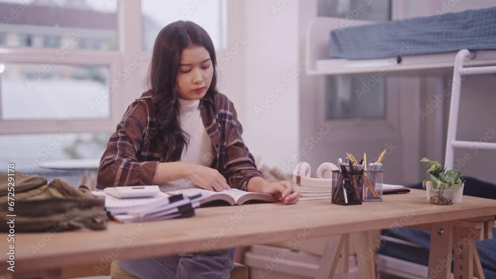 Asian schoolgirl in her study attire is immersed in her books, preparing diligently for an upcoming exam. Her commitment is so unwavering that she finds herself dozing off on the desk i dorm room. Asian schoolgirl in her study attire is immersed in her books, preparing diligently for an upcoming exam. Her commitment is so unwavering that she finds herself dozing off on the desk i dorm room.