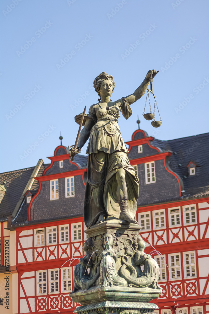 Frankfurt, Germany – Romerberg square, and fountain of justice in historical downtown with old timber houses during colorful sunset, cityscape Frankfurt, Germany – Romerberg square, and fountain of justice in historical downtown with old timber houses during colorful sunset, cityscape