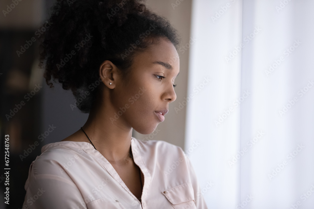 Thoughtful sad millennial Black d girl looking out of window in deep thoughts, thinking over heartbreak problems, feeling boredom, melancholy, suffering from negative mood, depression, Thoughtful sad millennial Black d girl looking out of window in deep thoughts, thinking over heartbreak problems, feeling boredom, melancholy, suffering from negative mood, depression,