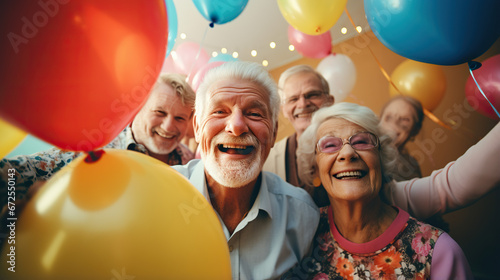 happy excited pensioners during a birthday.group of people with balloons © SizeSquare's