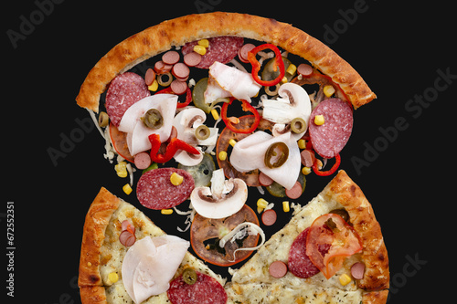italian pizza with vegetables and meat on a black background