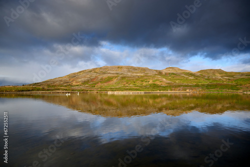 Scenic view of calm lake against hills © Cavan
