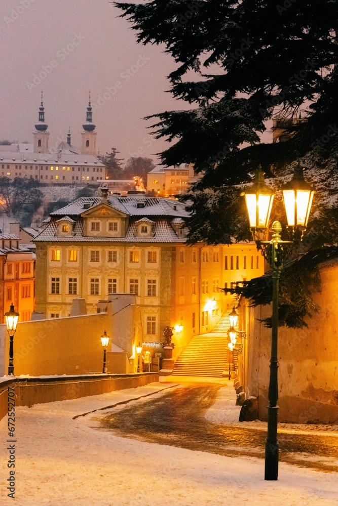 Winter twilight in Prague, snow, no one, lights on, city center