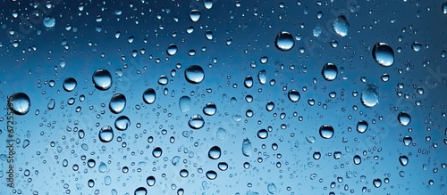 Water droplets falling on the window pane