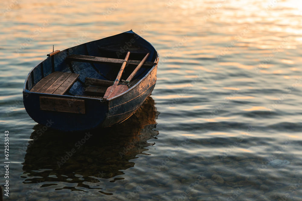 Canoe with paddles on a lake that resembles a beautiful painting