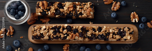 Muesli Bars with fresh Blueberries on wooden background. zesty blueberry granola bars. © PaulShlykov