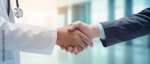 Doctor at the clinic shaking hands with his patient, concept of health care, and professionalism Doctor and patient meeting at the hospital and shaking hands; healthcare and medicine banner photo
