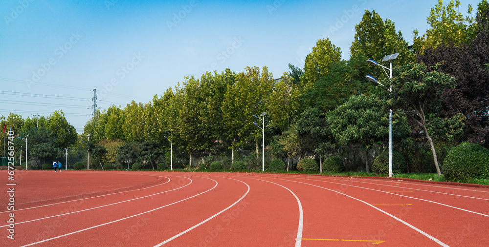 Fototapeta premium Athlete track or running track with green trees in the playground