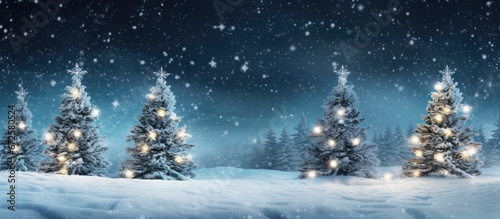 In the evening garlands adorned with snow gracefully embrace Christmas trees adorned with ornaments and lights © 2rogan