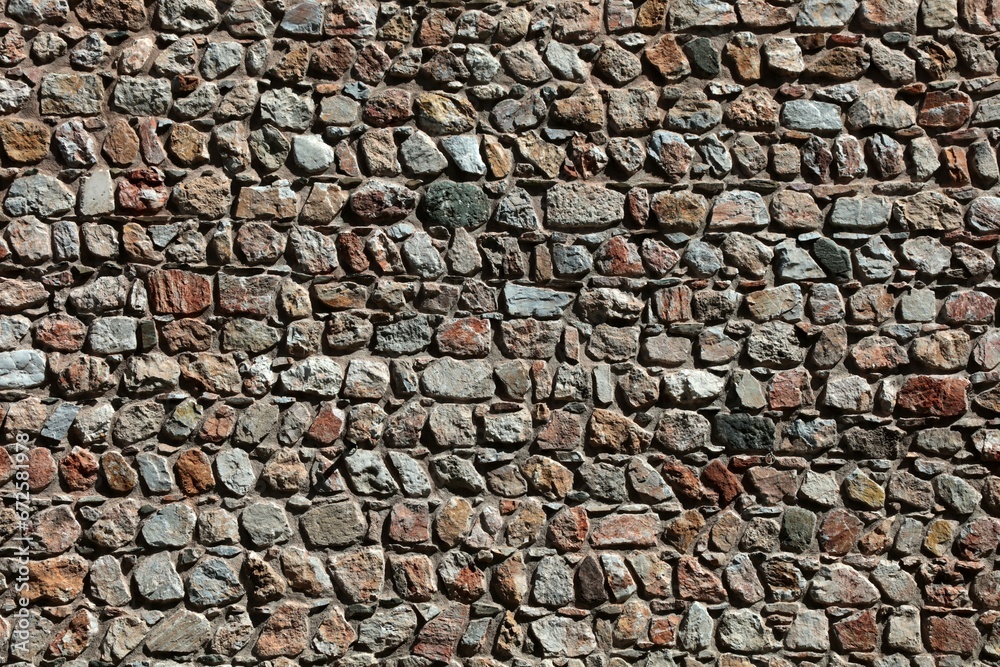 A wall made of rubble stones. Stone wall detail for backgrounds.