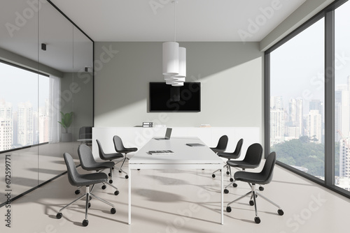 Stylish meeting room interior with chairs and table near panoramic window