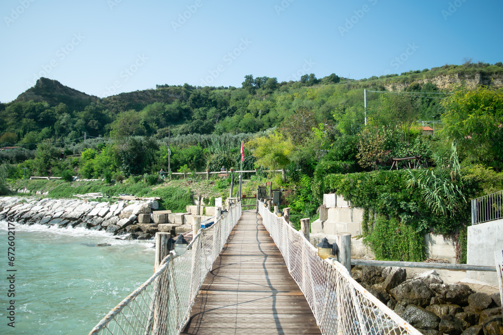 Scenic view of walkway against mountains and blue sky