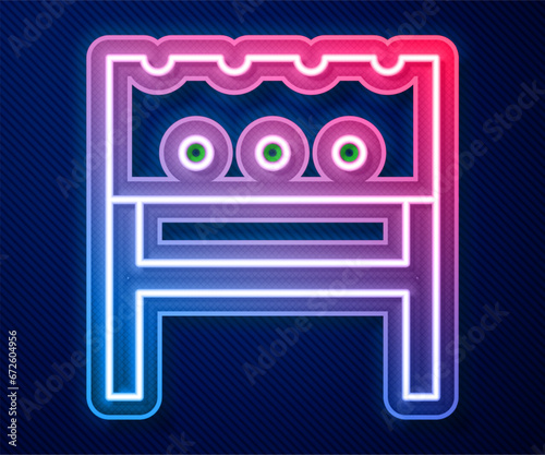 Glowing neon line BBQ brazier icon isolated on blue background. Vector