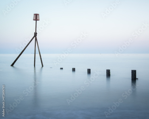 A calming long exposure shot of the sea and groynes