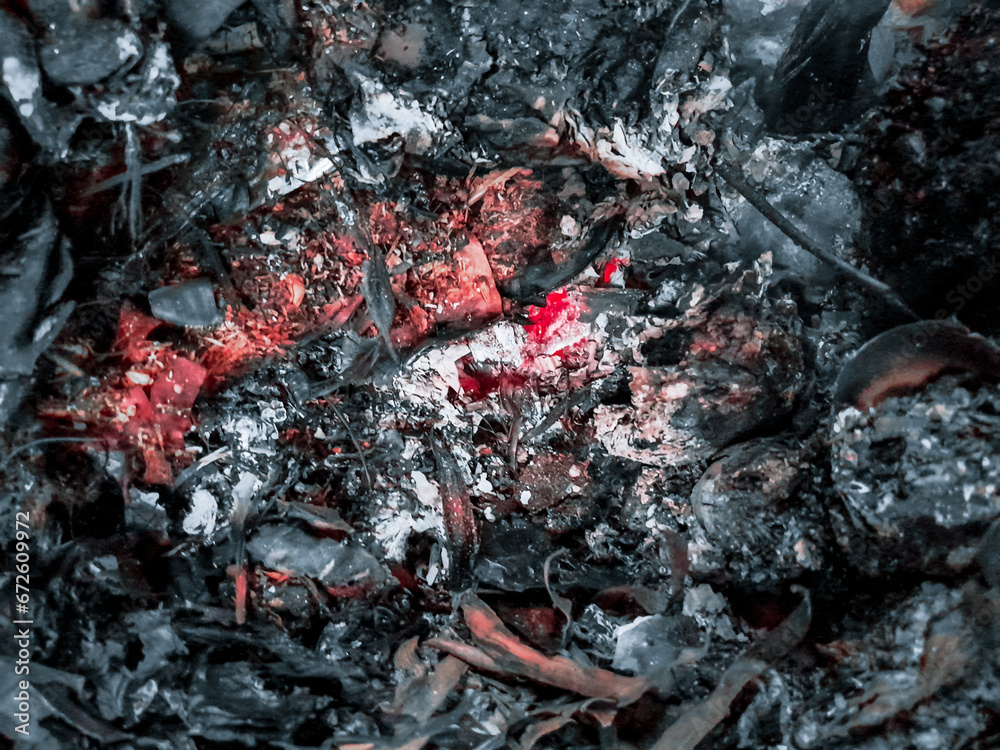 Close up of a Burning fall leaves in the incinerator. White smoke and Ashes left over from burning rubbish. Close up of a Burning fall leaves in the incinerator. White smoke and Ashes left over from burning rubbish.