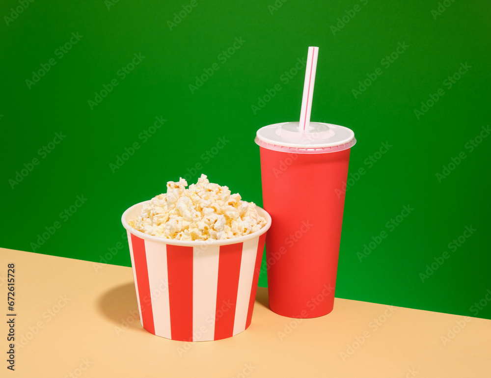 A bucket of popcorn and a drink, a fun weekend. Cinema industry concept.