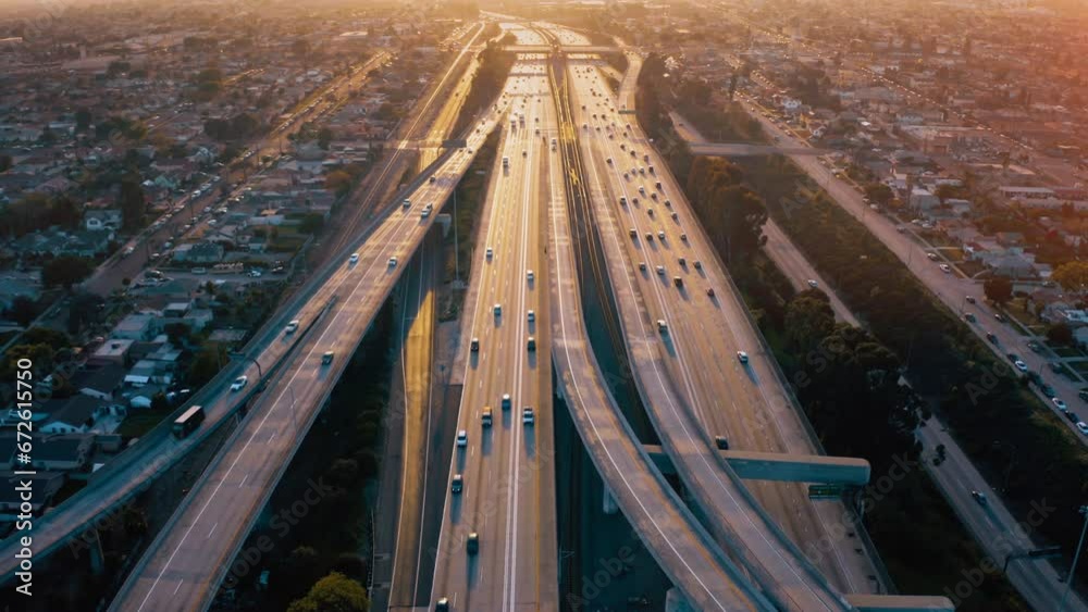 Top view drone rising above incredible complex highway junction in Los Angeles. Aerial Shot of Los Angeles Downtown. 