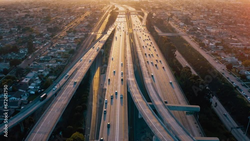 Top view drone rising above incredible complex highway junction in Los Angeles. Aerial Shot of Los Angeles Downtown.  photo